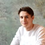 Handsome young smiling guy in white t-shirt